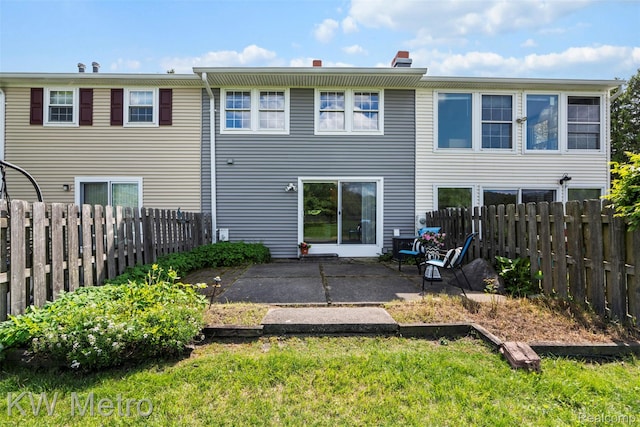 20094 Bryn Mawr Ct Unit 166, Northville, MI 48167 - back of house with a patio area, a fenced backyard, and a chimney