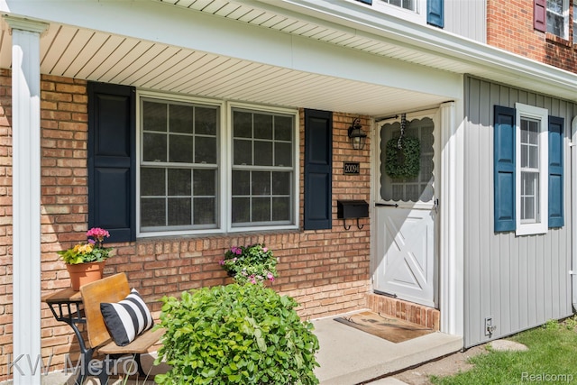 20094 Bryn Mawr Ct Unit 166, Northville, MI 48167 - entrance to property with brick siding, a porch, and board and batten siding
