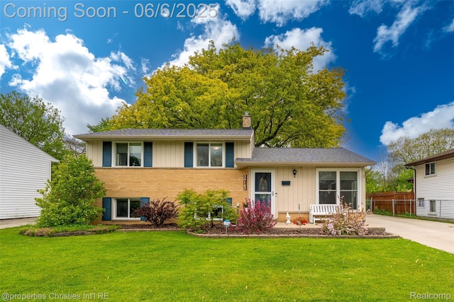 34143 Zimmer Dr, Sterling Heights, MI 48310 - tri-level home featuring board and batten siding, brick siding, a chimney, and a shingled roof