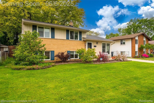 34143 Zimmer Dr, Sterling Heights, MI 48310 - back of property with board and batten siding, a chimney, and brick siding