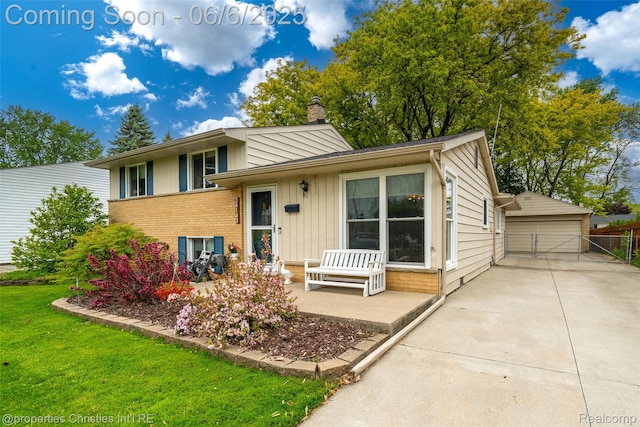 34143 Zimmer Dr, Sterling Heights, MI 48310 - split level home with a chimney, a garage, brick siding, and board and batten siding