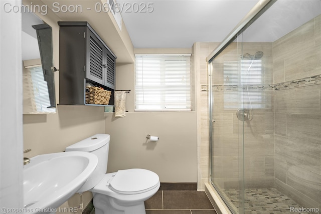 34143 Zimmer Dr, Sterling Heights, MI 48310 - bathroom with a sink, a stall shower, tile patterned flooring, toilet, and baseboards