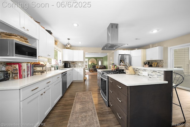 34143 Zimmer Dr, Sterling Heights, MI 48310 - kitchen with island range hood, appliances with stainless steel finishes, white cabinetry, a kitchen bar, and backsplash