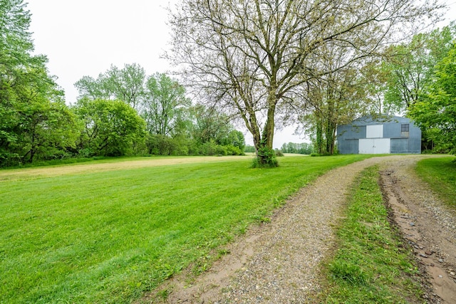 8324 Hagar Shore Rd, Watervliet, MI 49098 - view of green lawn with an outbuilding, driveway, an outdoor structure, and a detached garage