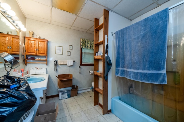 8324 Hagar Shore Rd, Watervliet, MI 49098 - bathroom featuring a paneled ceiling, vanity, baseboard heating, tile patterned flooring, and toilet
