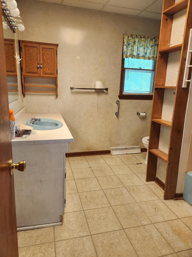 8324 Hagar Shore Rd, Watervliet, MI 49098 - bathroom featuring vanity, baseboard heating, toilet, baseboards, and tile patterned floors