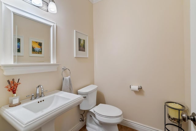 4132 Winding Way, Kalamazoo, MI 49004 - bathroom featuring baseboards, toilet, and a sink
