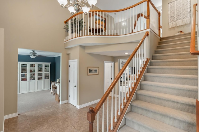 4132 Winding Way, Kalamazoo, MI 49004 - staircase with a high ceiling, baseboards, a chandelier, tile patterned flooring, and a ceiling fan