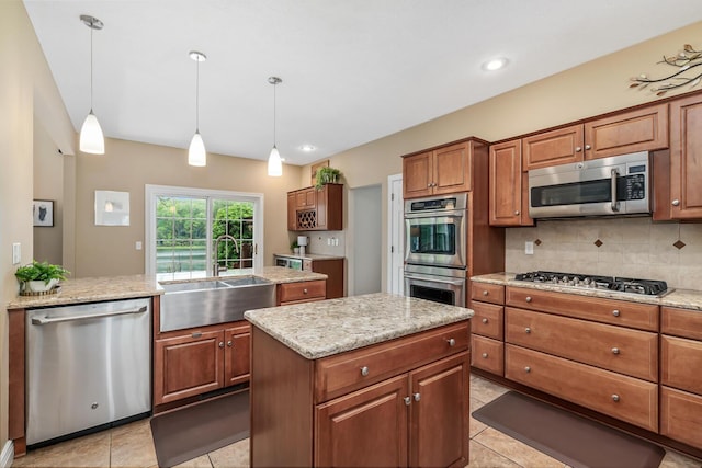 4132 Winding Way, Kalamazoo, MI 49004 - kitchen featuring appliances with stainless steel finishes, a sink, brown cabinets, backsplash, and a center island
