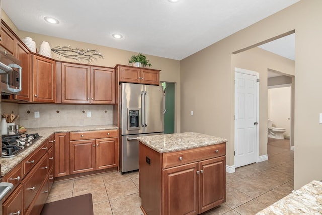 4132 Winding Way, Kalamazoo, MI 49004 - kitchen with stainless steel appliances, light tile patterned flooring, tasteful backsplash, light stone counters, and recessed lighting
