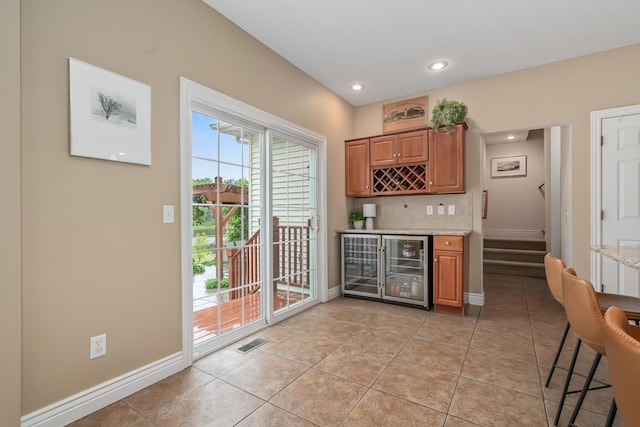4132 Winding Way, Kalamazoo, MI 49004 - kitchen featuring light tile patterned flooring, recessed lighting, tasteful backsplash, baseboards, and brown cabinetry