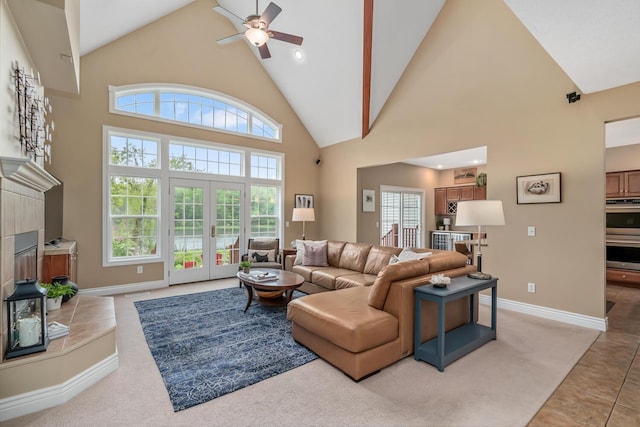 4132 Winding Way, Kalamazoo, MI 49004 - living room featuring high vaulted ceiling, ceiling fan, plenty of natural light, a tiled fireplace, and baseboards