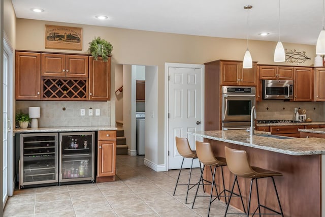 4132 Winding Way, Kalamazoo, MI 49004 - kitchen featuring stainless steel appliances, brown cabinets, a breakfast bar area, decorative backsplash, and recessed lighting