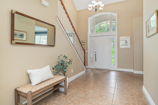 4132 Winding Way, Kalamazoo, MI 49004 - entrance foyer with a chandelier, stairs, a high ceiling, baseboards, and light tile patterned floors