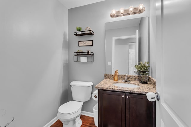449 Corinth Cir, Dundee, MI 48131 - half bathroom featuring toilet, vanity, wood finished floors, and baseboards