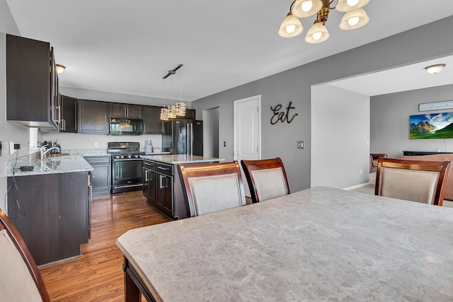 449 Corinth Cir, Dundee, MI 48131 - kitchen featuring black appliances, a chandelier, wood finished floors, a kitchen island, and a sink