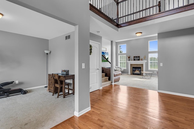 449 Corinth Cir, Dundee, MI 48131 - entryway featuring stairs, wood finished floors, a fireplace, baseboards, and a high ceiling