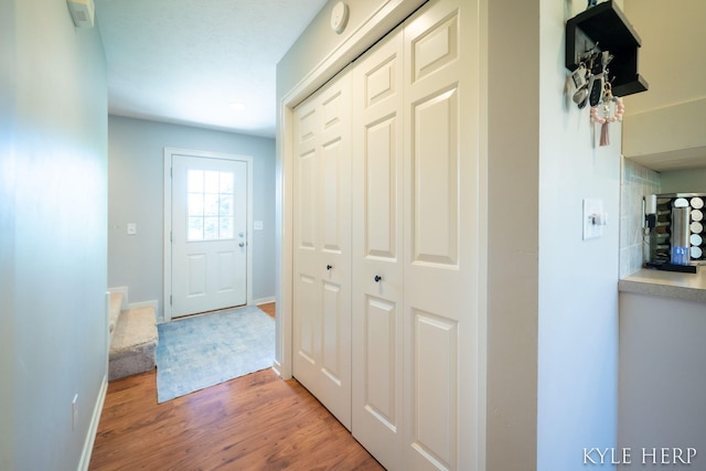 8718 Little Bend Ct, Middleville, MI 49333 - hallway with light wood-style floors and baseboards