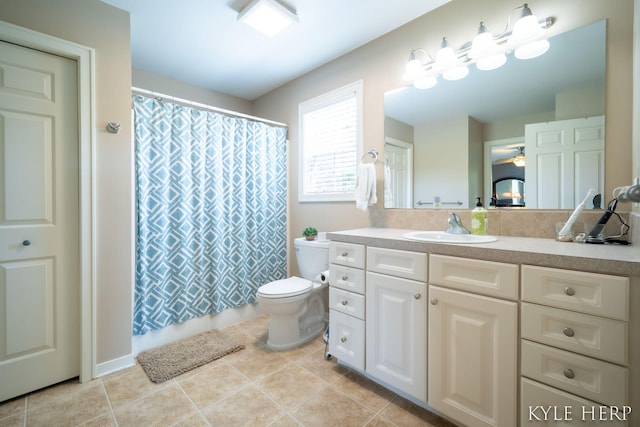 8718 Little Bend Ct, Middleville, MI 49333 - bathroom featuring toilet, vanity, tile patterned floors, a shower with shower curtain, and ceiling fan
