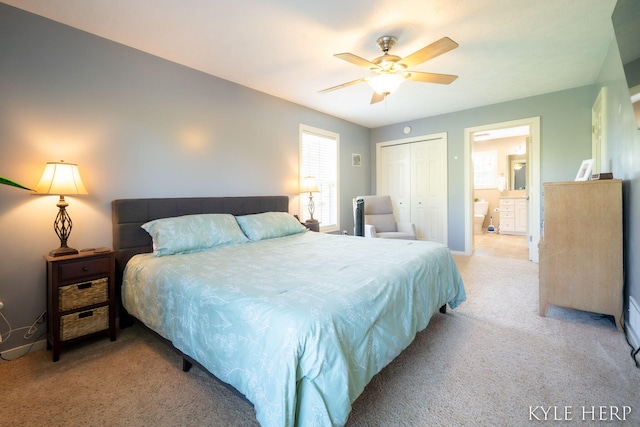 8718 Little Bend Ct, Middleville, MI 49333 - bedroom with light colored carpet, a closet, ceiling fan, and ensuite bath