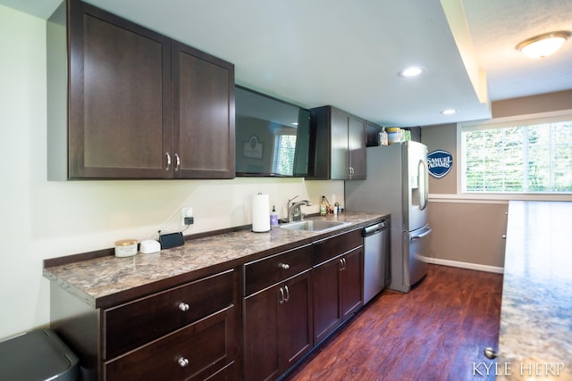 8718 Little Bend Ct, Middleville, MI 49333 - kitchen featuring a sink, dark wood-style flooring, stainless steel dishwasher, baseboards, and dark brown cabinetry