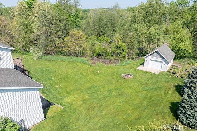 8718 Little Bend Ct, Middleville, MI 49333 - view of grassy yard featuring an outdoor structure, a view of trees, and a garage