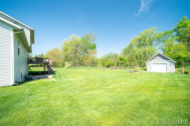8718 Little Bend Ct, Middleville, MI 49333 - view of grassy yard with stairs, a deck, an outbuilding, and a garage