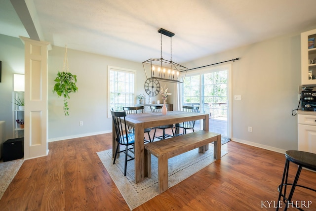 8718 Little Bend Ct, Middleville, MI 49333 - dining room featuring plenty of natural light, wood finished floors, baseboards, and a chandelier