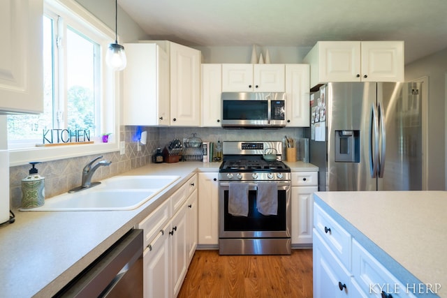 8718 Little Bend Ct, Middleville, MI 49333 - kitchen with appliances with stainless steel finishes, a sink, healthy amount of natural light, and light countertops