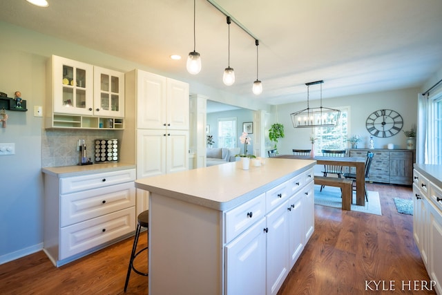 8718 Little Bend Ct, Middleville, MI 49333 - kitchen featuring glass insert cabinets, light countertops, a kitchen island, backsplash, and recessed lighting