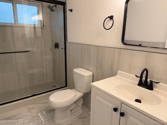 29054 Burning Tree Ln, Romulus, MI 48174 - bathroom featuring marble finish flooring, toilet, a stall shower, vanity, and wainscoting