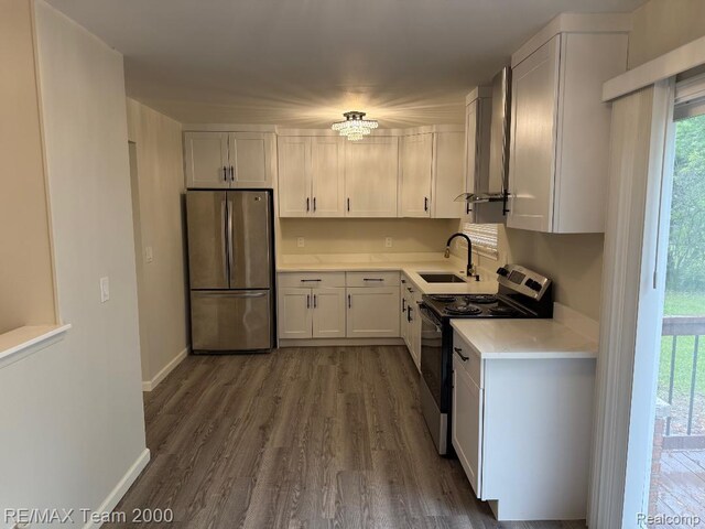 29054 Burning Tree Ln, Romulus, MI 48174 - kitchen with freestanding refrigerator, electric range, a sink, light countertops, and wall chimney exhaust hood