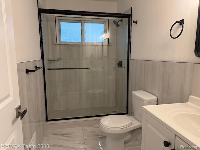 29054 Burning Tree Ln, Romulus, MI 48174 - full bathroom featuring marble look tile flooring, toilet, a shower stall, and wainscoting