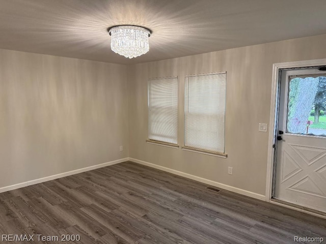 29054 Burning Tree Ln, Romulus, MI 48174 - foyer featuring a chandelier, dark wood-type flooring, and baseboards