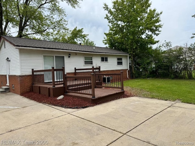 29054 Burning Tree Ln, Romulus, MI 48174 - rear view of house with a deck, a yard, brick siding, a patio area, and central air condition unit
