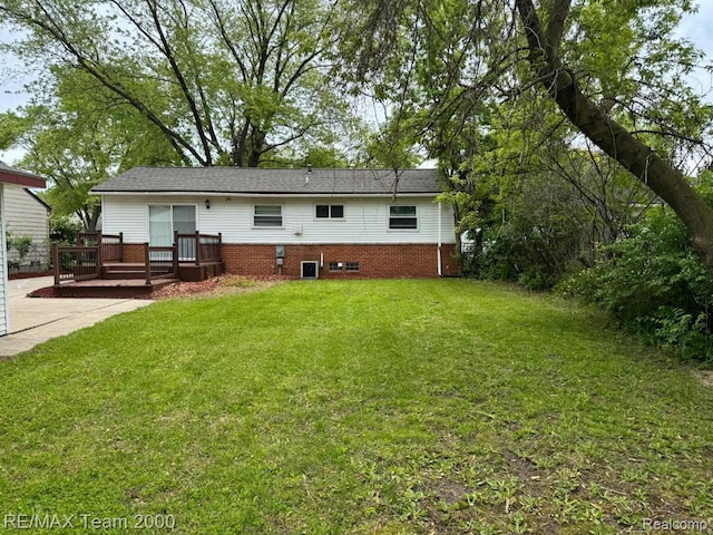 29054 Burning Tree Ln, Romulus, MI 48174 - rear view of house featuring a wooden deck, a lawn, brick siding, and central AC unit
