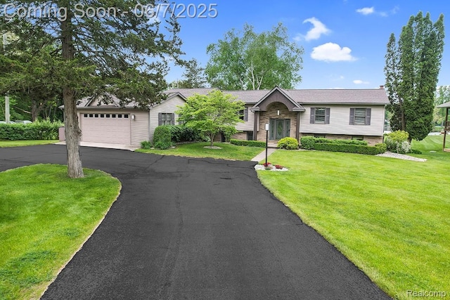 11404 Cedar Bend Dr, Pinckney, MI 48169 - view of front of property featuring a front yard, asphalt driveway, and a garage