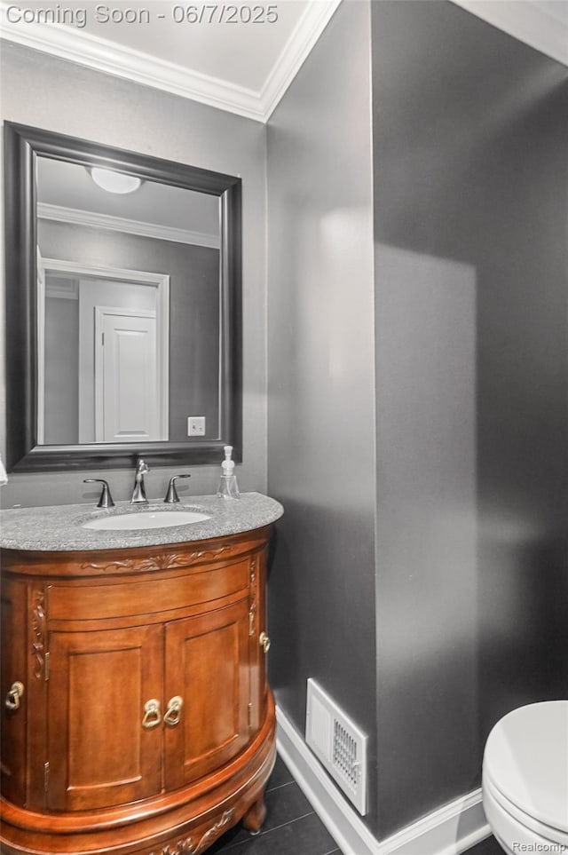 11404 Cedar Bend Dr, Pinckney, MI 48169 - bathroom with baseboards, vanity, crown molding, tile patterned flooring, and toilet
