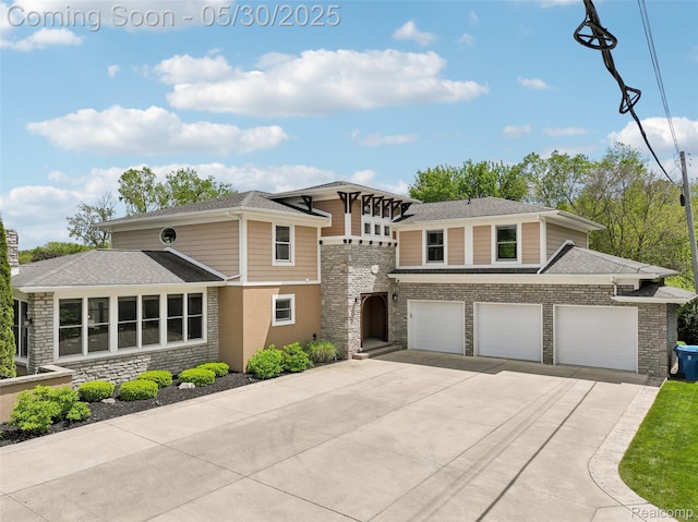 13525 Torrey Rd, Fenton, MI 48430 - prairie-style home with driveway, an attached garage, a shingled roof, and stone siding