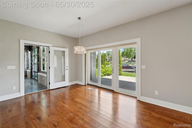 13525 Torrey Rd, Fenton, MI 48430 - unfurnished room featuring plenty of natural light, wood finished floors, baseboards, and french doors