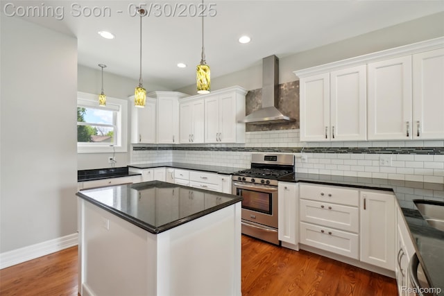 13525 Torrey Rd, Fenton, MI 48430 - kitchen featuring wall chimney exhaust hood, stainless steel range with gas cooktop, white cabinetry, backsplash, and recessed lighting