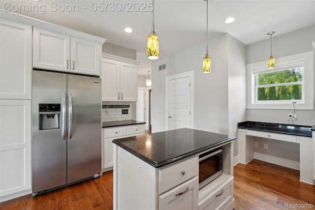 13525 Torrey Rd, Fenton, MI 48430 - kitchen with appliances with stainless steel finishes, dark countertops, tasteful backsplash, white cabinetry, and wood finished floors