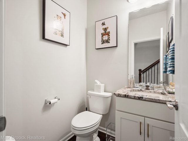 764 Hummingbird Dr, Rochester, MI 48307 - bathroom with toilet, vanity, and baseboards
