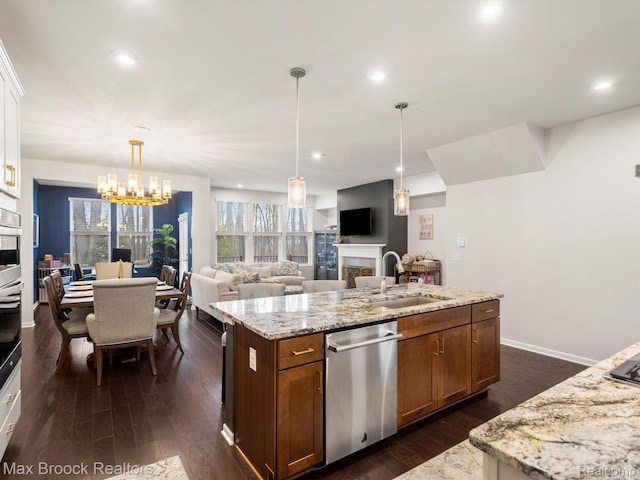 764 Hummingbird Dr, Rochester, MI 48307 - kitchen featuring stainless steel appliances, a fireplace, a sink, a kitchen island with sink, and dark wood-style flooring