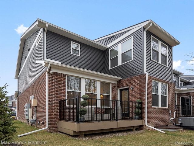 764 Hummingbird Dr, Rochester, MI 48307 - back of house featuring brick siding, central AC, and a deck