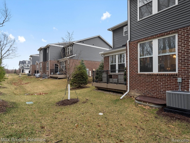 764 Hummingbird Dr, Rochester, MI 48307 - view of green lawn with central air condition unit and a deck