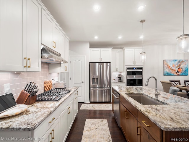 764 Hummingbird Dr, Rochester, MI 48307 - kitchen with stainless steel appliances, under cabinet range hood, a sink, a kitchen island with sink, and white cabinets