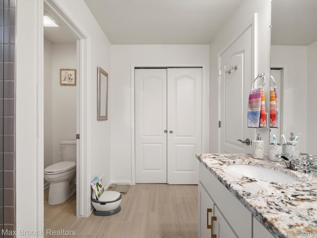764 Hummingbird Dr, Rochester, MI 48307 - bathroom featuring toilet, vanity, and baseboards