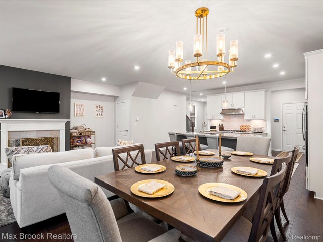 764 Hummingbird Dr, Rochester, MI 48307 - dining space with dark wood-style flooring, recessed lighting, a chandelier, and a fireplace