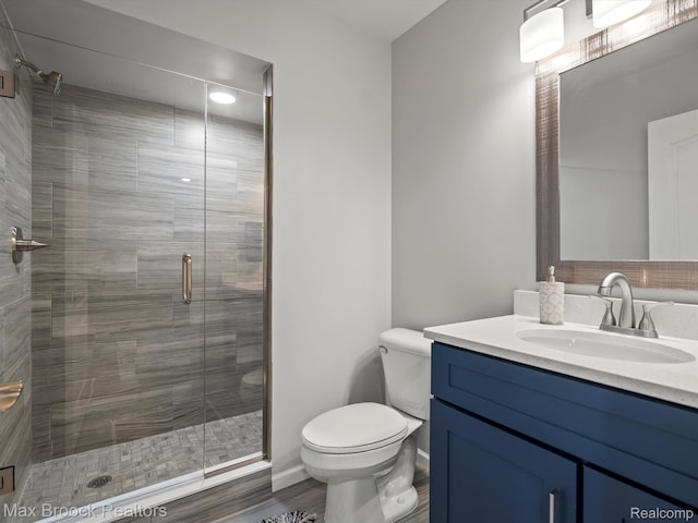 764 Hummingbird Dr, Rochester, MI 48307 - bathroom featuring vanity, toilet, a stall shower, wood finished floors, and baseboards